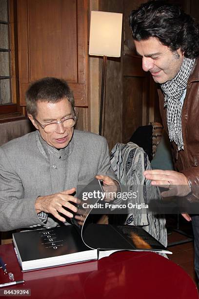 Artist Jean-Paul Goude signs his book "Tutto Goude" during the "So Far So Goude" event held at the Villa Medici on January 24, 2009 in Rome, Italy.