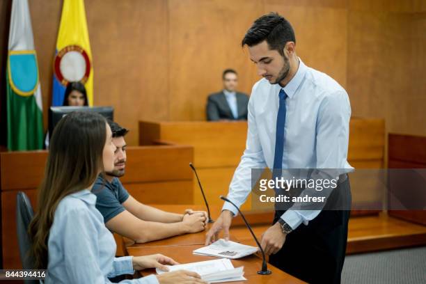 lawyer showing evidence in trial at a colombian courtroom - legal defense stock pictures, royalty-free photos & images