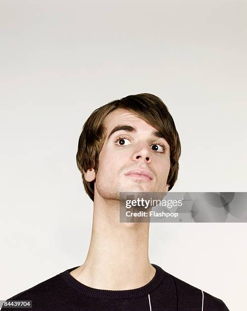 man stretching his neck - crecimiento estirón fotografías e imágenes de stock