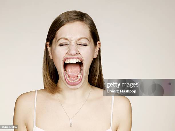 woman shouting with big mouth - screaming mouth stock pictures, royalty-free photos & images