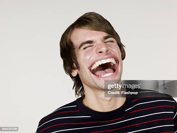 portrait of man with big mouth laughing - mundraum stock-fotos und bilder