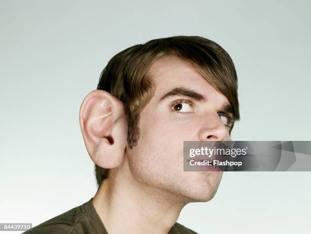 portrait of man with big ear listening - interested listener stock-fotos und bilder