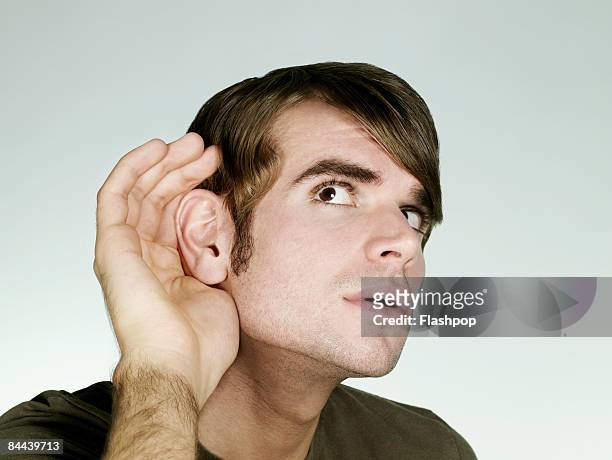 portrait of man listening - listening stockfoto's en -beelden