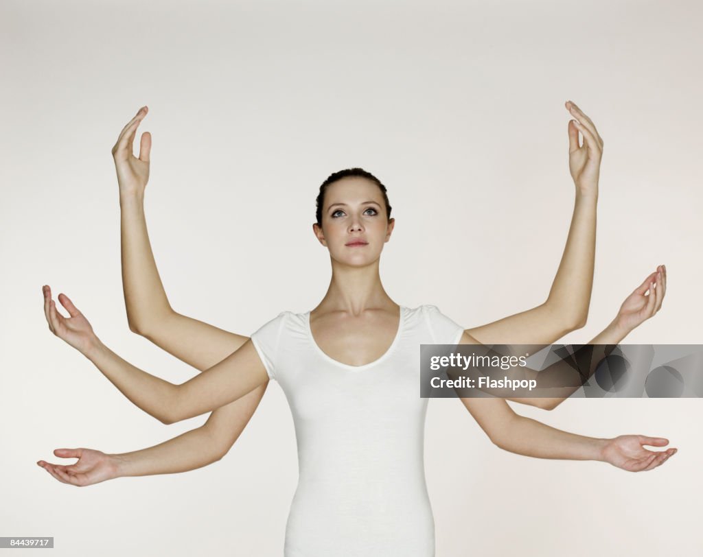 Woman with three pairs of arms and hands