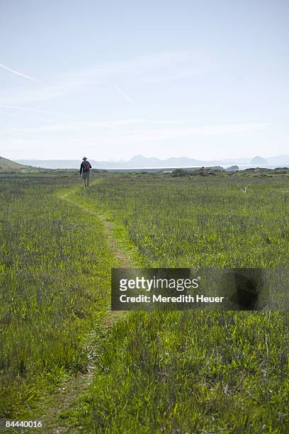 father carries son on trail - cayucos stockfoto's en -beelden