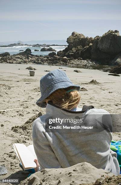 woman reads on beach - cayucos stock pictures, royalty-free photos & images