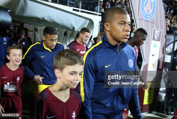 Kylian Mbappe and Neymar Jr of PSG enter the pitch prior to the French Ligue 1 match between FC Metz and Paris Saint Germain at Stade...