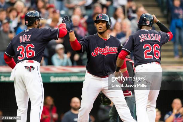 Yandy Diaz and Austin Jackson celebrate with Edwin Encarnacion of the Cleveland Indians after all scored on a home run by Encarnacion during the...