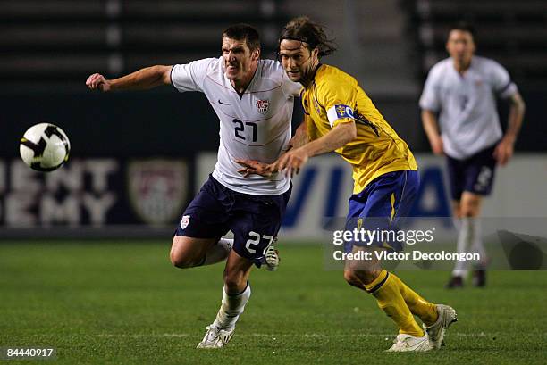 Kenny Cooper of the USA and Daniel Andersson of Sweden vie for position to the ball in the second half during their international friendly match at...