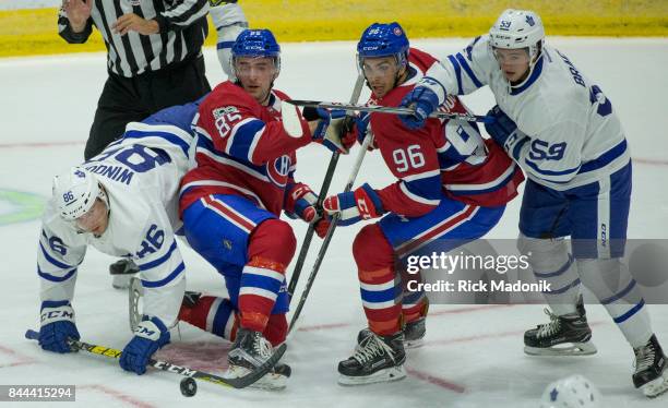 Josh Winquist watches the puck after the drop as Canadians Thomas Ebbing and Jordan Boucher all get mixed up along with Leafs Jeremy Bracco . Toronto...