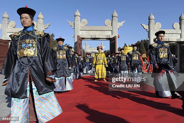 Actors dressed in Qing Dynasty costumes take part in an opening ceremony for the Ditan Temple Fair in Beijing on January 25, 2009. The annual fair...