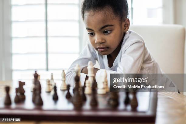 young girl (6yrs) playing chess with - kids playing chess stock pictures, royalty-free photos & images