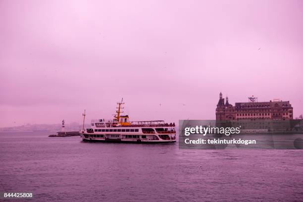 traditional city passenger boat is in front of old haydarpasa train station at istanbul - haydarpasa stock pictures, royalty-free photos & images