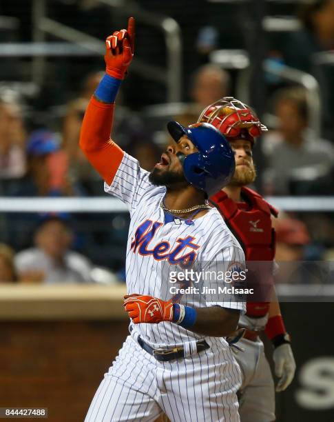 Jose Reyes of the New York Mets celebrates his third inning home run as Tucker Barnhart of the Cincinnati Reds looks on at Citi Field on September 8,...