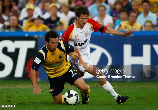 John Hutchinson of the Mariners competes with Michael Marrone of United during the round 21 A-League match between the Central Coast Mariners and...