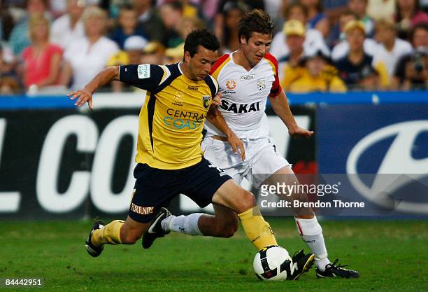 John Hutchinson of the Mariners competes with Michael Marrone of United during the round 21 A-League match between the Central Coast Mariners and...