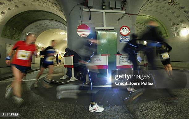 Athletes run through Hamburg's old Elbtunnel undercrossing the Elbe river during the 10th edition of the northern city's traditional Elbtunnel...