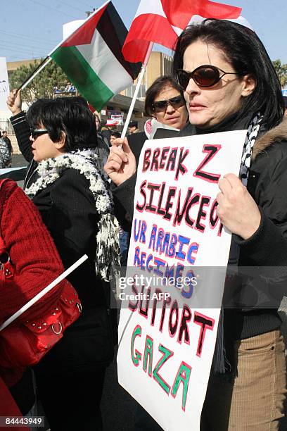 Arab women from countries bordering Israel, holding placards in support of Gaza and waving Lebanese and Palestinian flags, demonstrate at Fatima's...