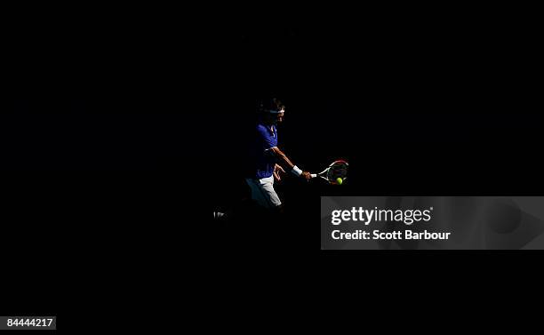 Roger Federer of Switzerland plays a backhand in his fourth round match against Tomas Berdych of the Czech Republic during day seven of the 2009...