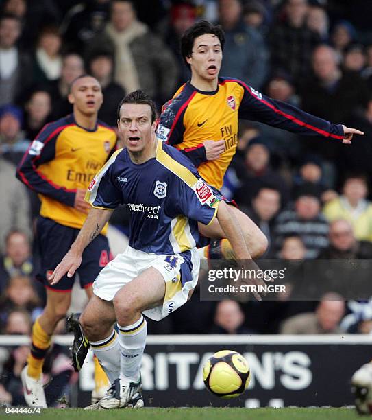 Cardiff City's Gavin Rae vies for the ball against Arsenal's French player Samir Nasri during the FA Cup 4th round match at Ninian Park in Cardiff on...