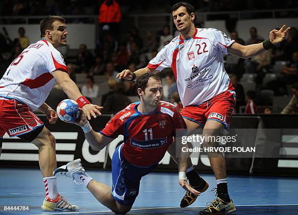 Serbia's Alem Toskic tries to score in front of Poland's Michal Jurecki and Marcin Lijewski during their World Handball Championship match in Zadar...