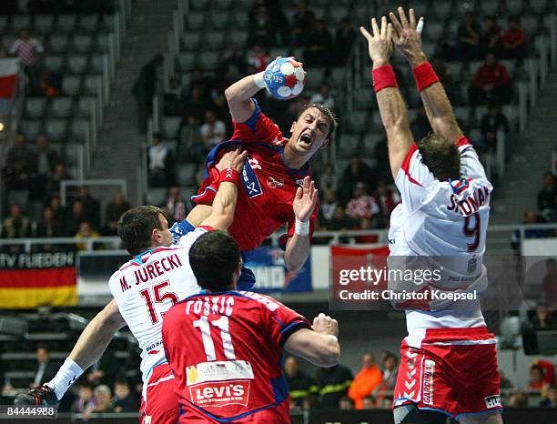 Michal Jurecki of Poland tackles Momir Ilic of Serbia during the Men's World Handball Championships main round match group two between Serbia and...