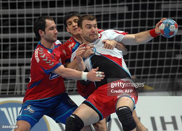 Poland's Bartosz Jurecki vies with Serbia's Alem Toskic and Nenad Vuckovic during their World Handball Championship match in Zadar on January 25,...