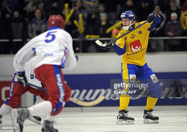 Sweden's Patrik Nilsson, right, controls the ball while Russia''s Andrey Zolotarev comes skating from the left, during the final of the bandy World...