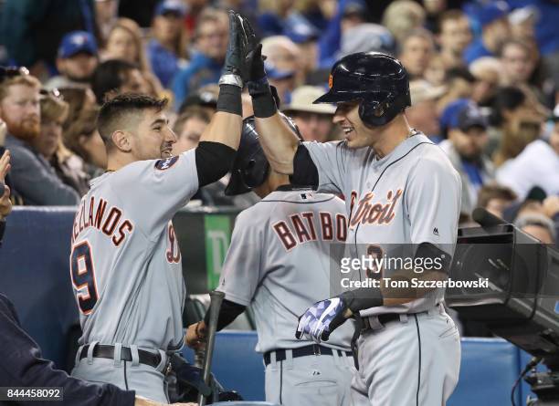 Ian Kinsler of the Detroit Tigers is congratulated by Nick Castellanos after hitting a solo home run in the seventh inning during MLB game action...