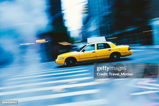 yellow cab with panning motion in new york city - yellow taxi stock pictures, royalty-free photos & images