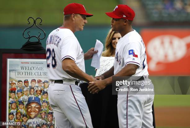 Manager Jeff Banister congratulates Adrian Beltre of the Texas Rangers during a pre-game ceremony celebrating Beltre's 3000th hit before the New York...