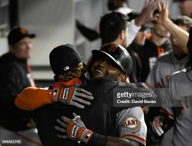 Pablo Sandoval of the San Francisco Giants is greeted by his teammates after hitting a three-run homer against the Chicago White Sox during the...