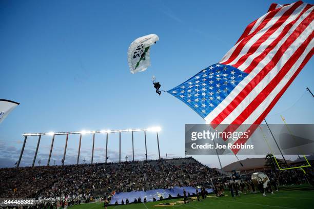The game ball is delivered via sky diver under new lights for the Purdue Boilermakers prior to a game against the Ohio Bobcats at Ross-Ade Stadium on...