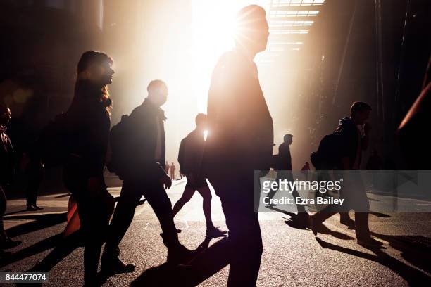 business people walking through the city at dawn. - road safety stock pictures, royalty-free photos & images