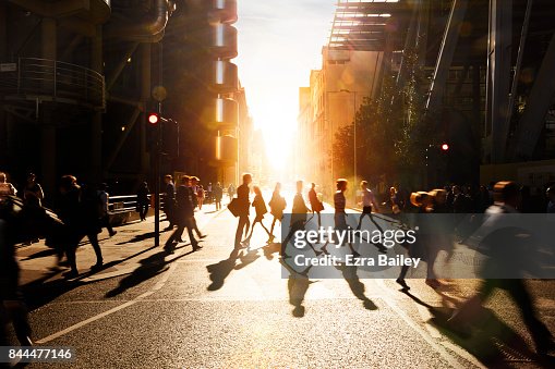 Business people walking through at city at dawn. Business people walking through at city at dawn.