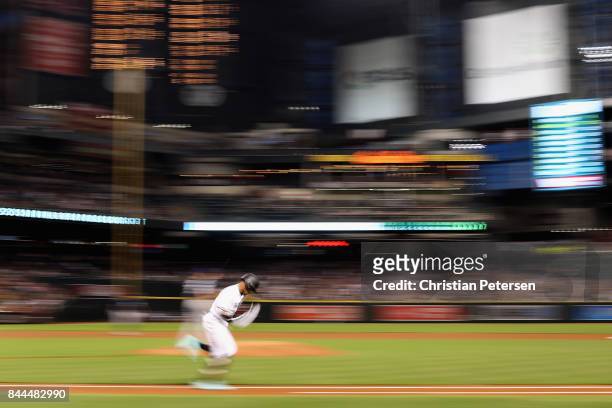Ketel Marte of the Arizona Diamondbacks runs out a single during the first inning of the MLB game against the San Diego Padres at Chase Field on...