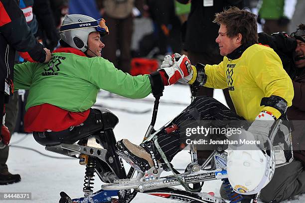 Van der Klooster in yellow congratulates gold medal winner Tyler Walker in green after the Mono Skier X Finals Winter X Games Day 4 on Buttermilk...