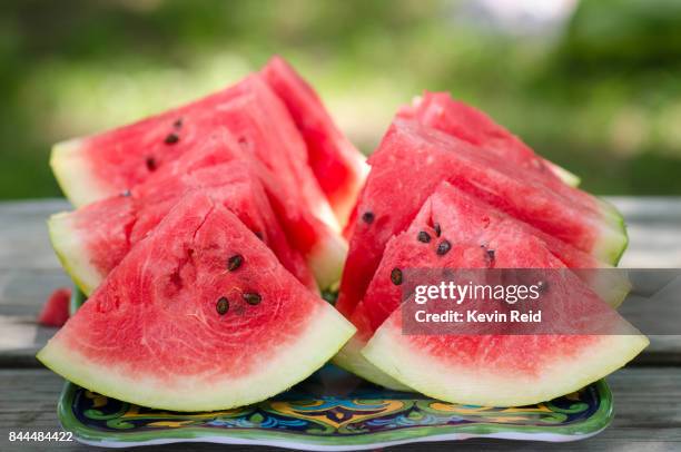 freshly cut watermelon slices - wassermelone stock-fotos und bilder