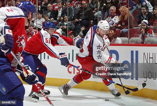 Western Conference All-Star Shane Doan of the Phoenix Coyotes skates with the puck under pressure from Eastern Conference All-Star Dany Heatley of...