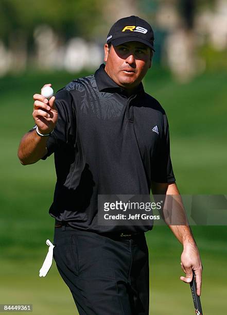 Pat Perez acknowledges the gallery after making a par putt on the eighth hole during the final round of the Bob Hope Chrysler Classic at the Palmer...