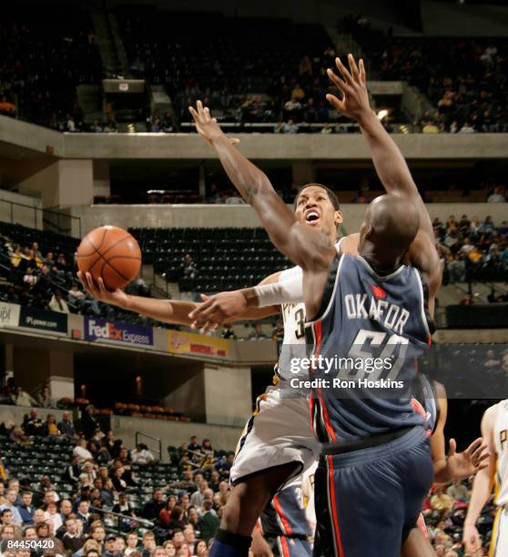 Danny Granger of the Indiana Pacers looks to score over Emeka Okafor of the Charlotte Bobcats at Conseco Fieldhouse on January 25, 2009 in...