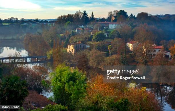 rural village with river and bridge - vendée fotografías e imágenes de stock