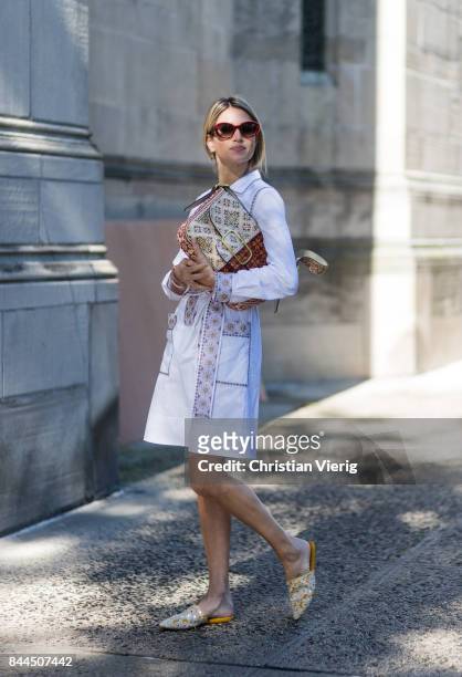 Helena Bordon wearing white dress, clutch, slippers seen in the streets of Manhattan outside Tory Burch during New York Fashion Week on September 8,...