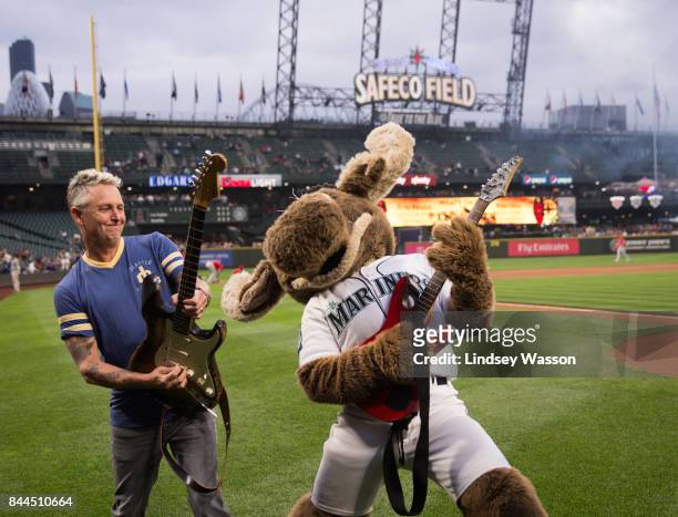 Mike McCready of Pearl Jam poses with the Mariner Moose after performing the national anthem before the game between the Seattle Mariners and the Los...