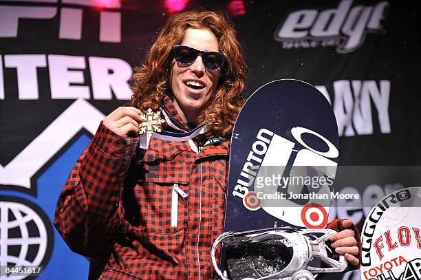 Shaun White of Carlsbad, California celebrates as he takes the podium for the gold medal in the Men's Snowboard Superpipe Final at Winter X Games 13...