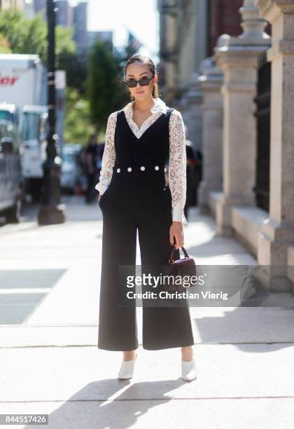 Chriselle Lim wearing black overall seen in the streets of Manhattan outside Tory Burch during New York Fashion Week on September 8, 2017 in New York...