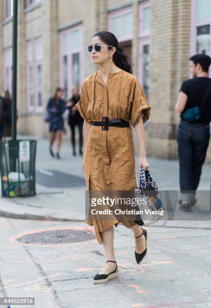 Caroline Issa wearing a brown dress with belt seen in the streets of Manhattan outside Jason Wu during New York Fashion Week on September 8, 2017 in...
