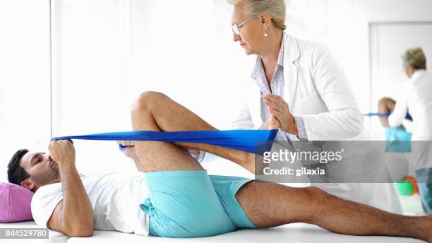 young man in physical therapy. - hips stock pictures, royalty-free photos & images