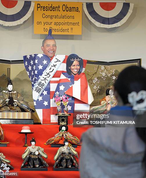 Visitors watch the Girls' Festival dolls and dolls of US new President Barack Obama and first lady Michelle in Kawaguchi city, Saitama prefecture,...