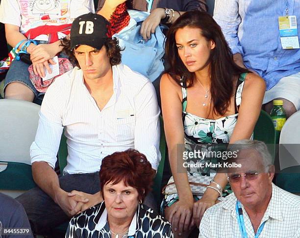 Comedian Andy Lee and model Megan Gale watch the fourth round match between Jo-Wilfried Tsonga of France and James Blake of the United States of...
